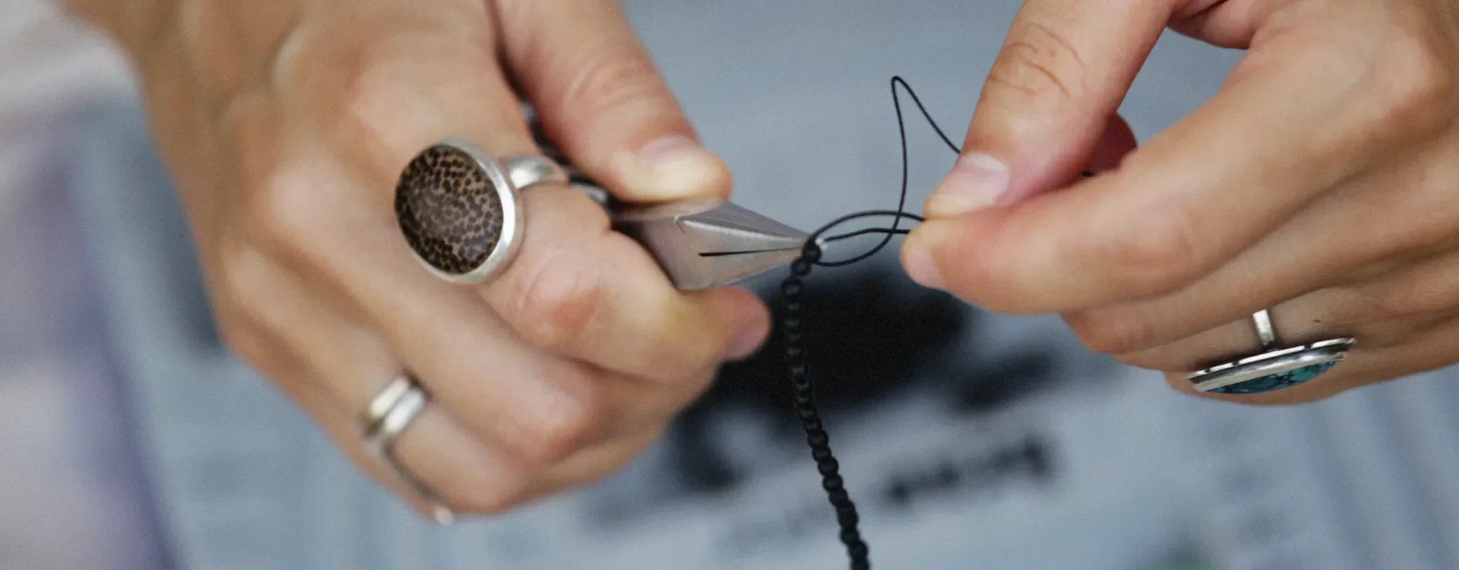 woman's hand creating jewelry reposted by Made for Freedom