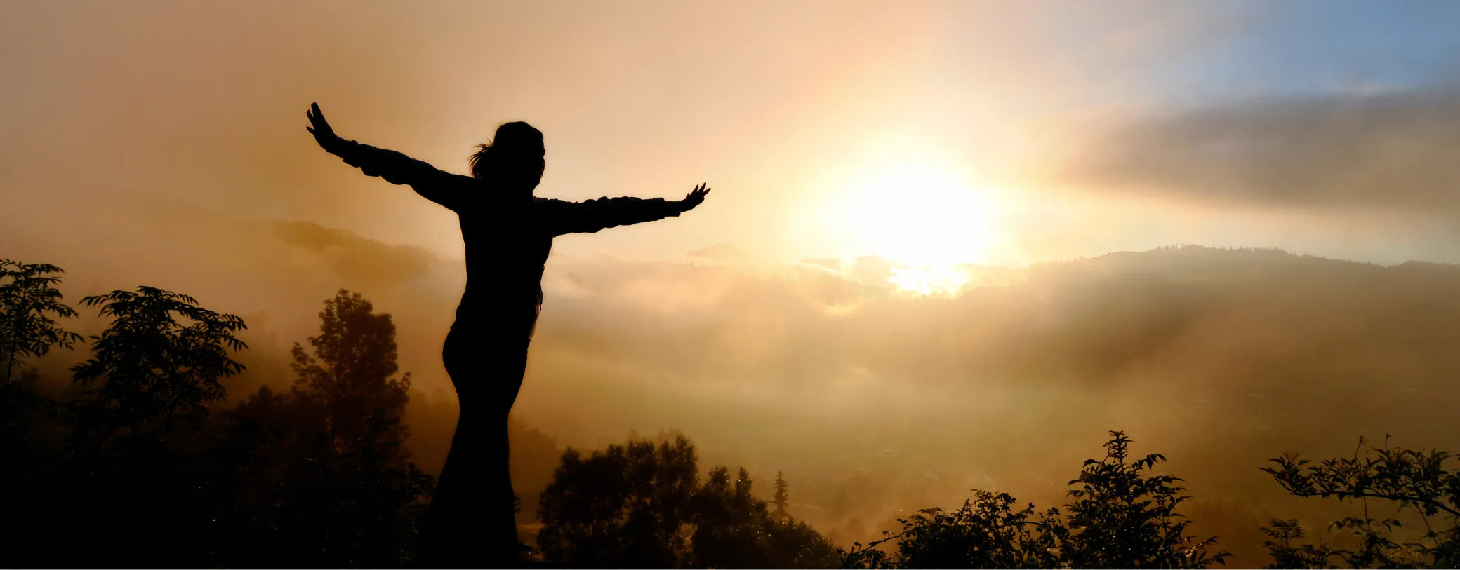 a silhouette of a woman expressing freedom during sunset reposted by Made for Freedom