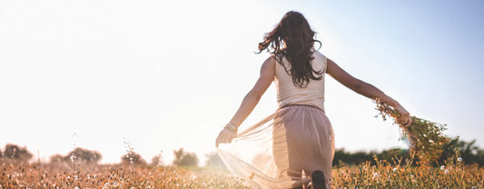 a woman freely running through the meadows to signify freedom reposted by Made for Freedom
