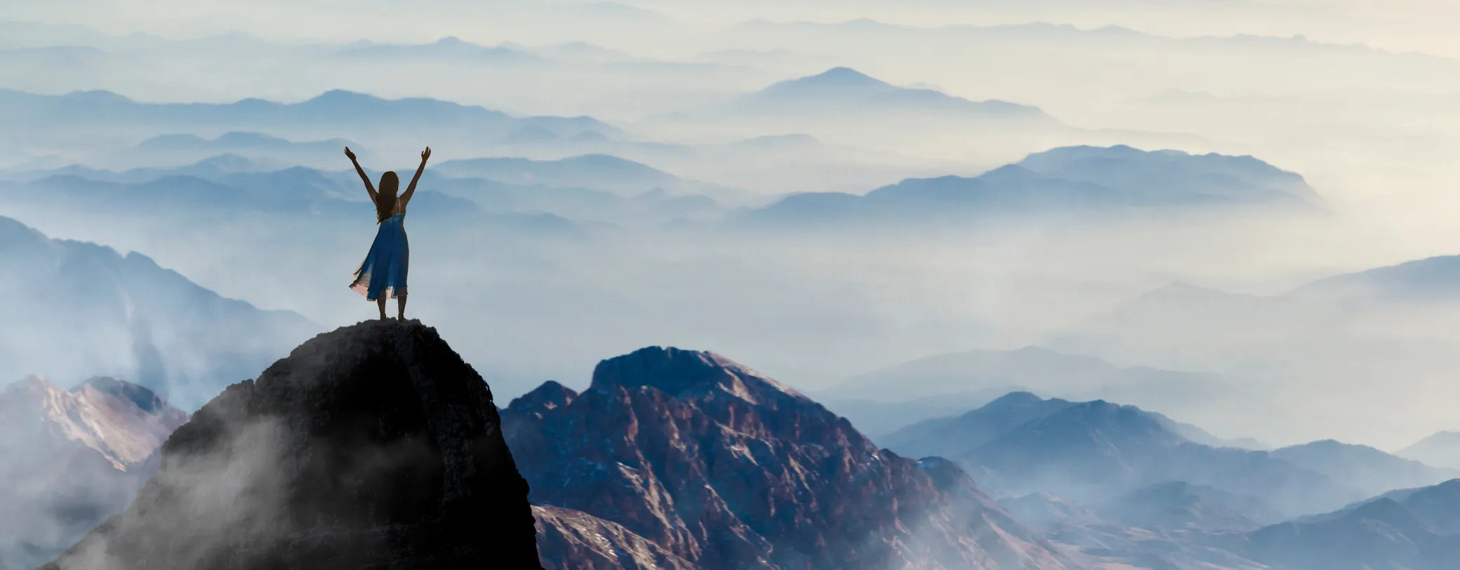 a woman on top of a mountain surrounded by a sea of clouds reposted by Made for Freedom