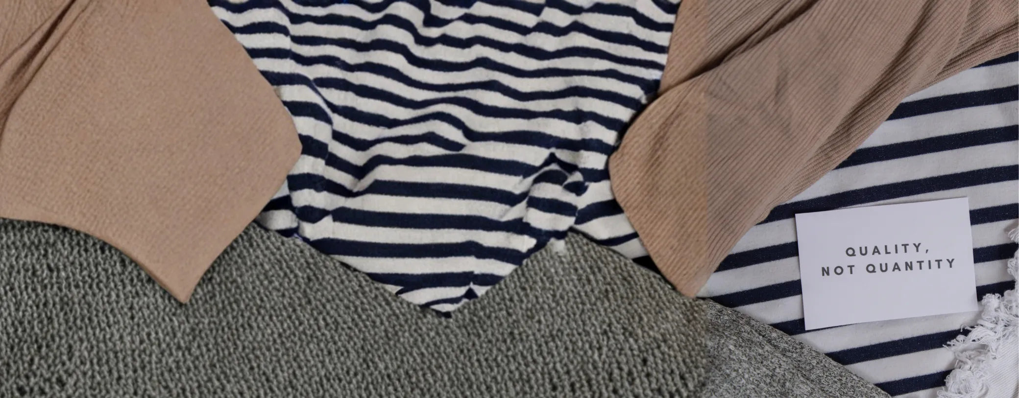a close-up shot of a pile of clothes with a tiny note saying "quality, not quantity" reposted by Made for Freedom
