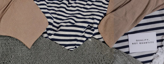 a close-up shot of a pile of clothes with a tiny note saying "quality, not quantity" reposted by Made for Freedom