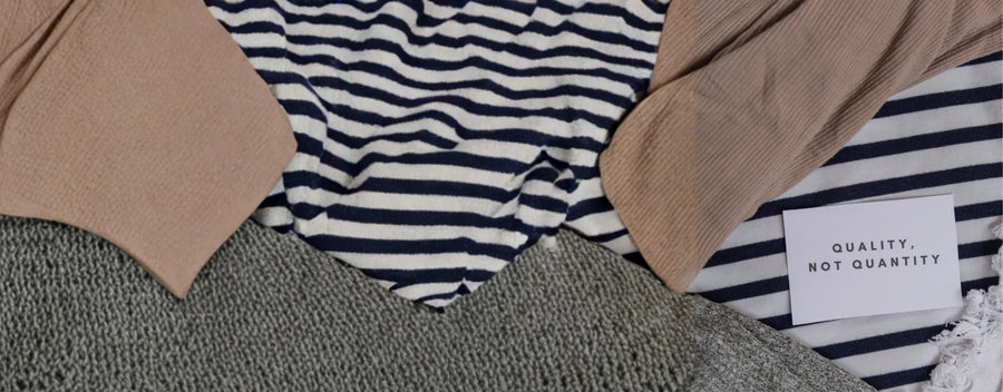 a close-up shot of a pile of clothes with a tiny note saying "quality, not quantity" reposted by Made for Freedom