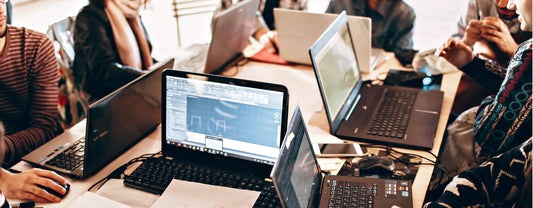 people gathered around a table using laptops reposted by Made for Freedom