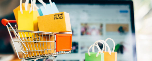 a small shopping cart containing goodies in front of an open computer reposted by Made for Freedom