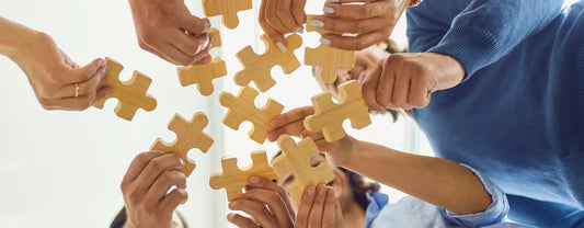 people gathered in a circle and holding out puzzle pieces reposted by Made for Freedom