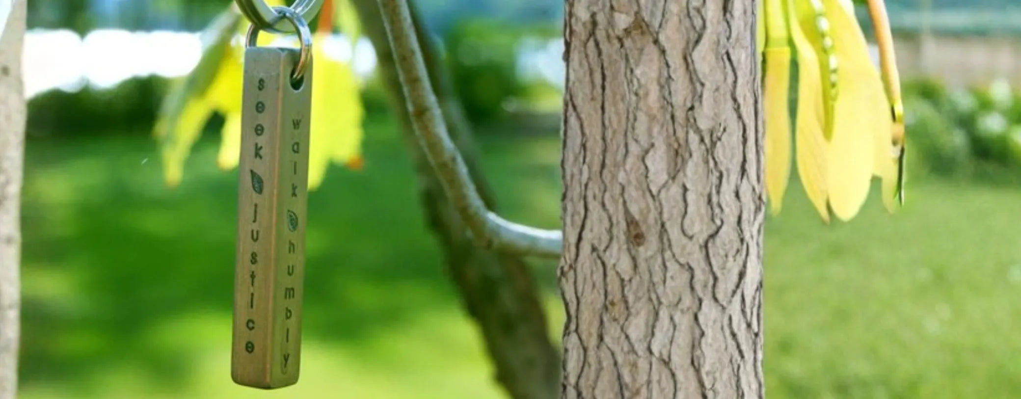 the Seek Justice Necklace from Made for Freedom hanging from a tree