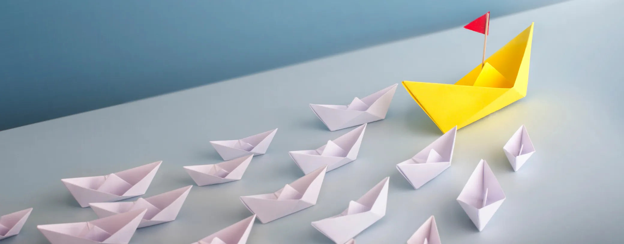 a group of paper boats  with one big yellow one leading in the front reposted by Made for Freedom