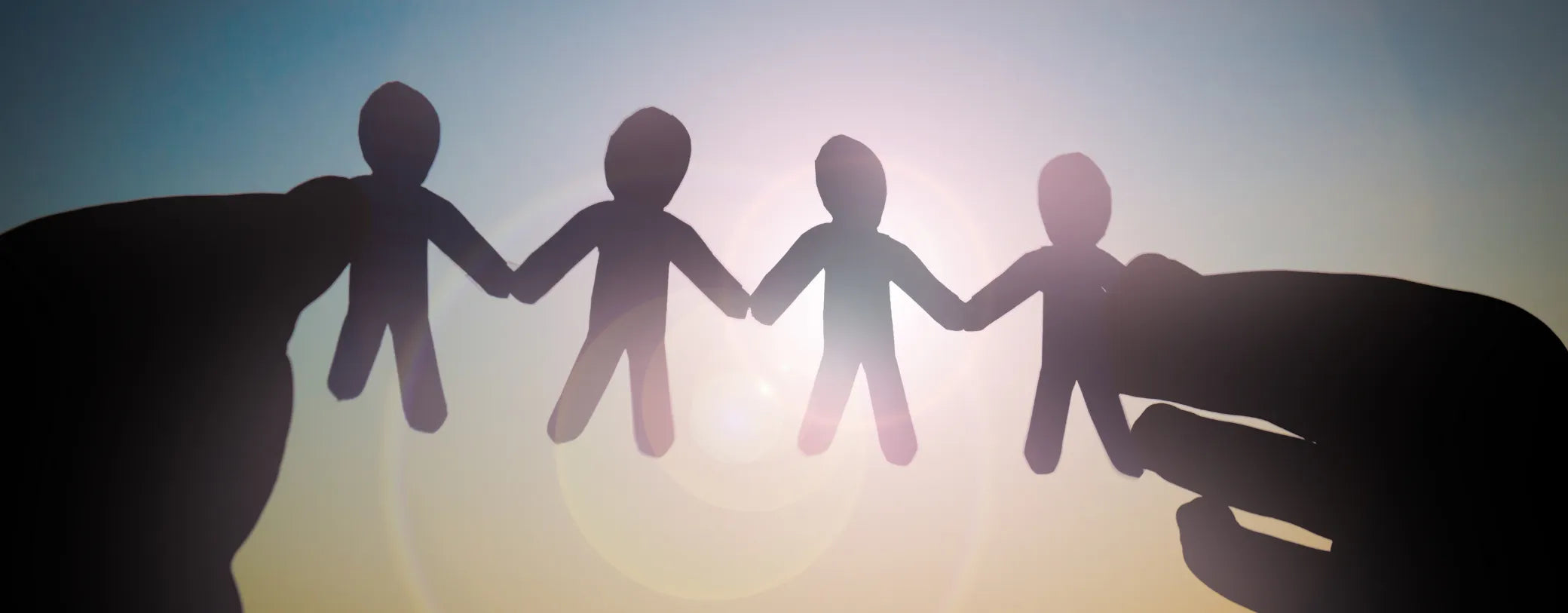 silhouette of hands holding paper cutouts shaped like people reposted by Made for Freedom