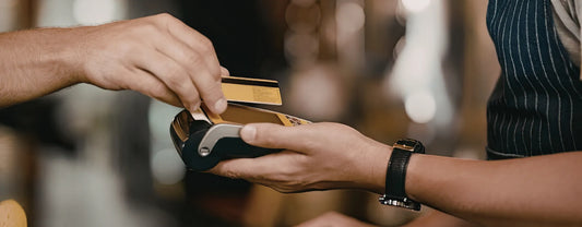 a hand holding a credit card while tapping it to a payment terminal reposted by Made for Freedom