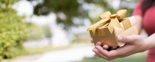 woman holding a gift box reposted by Made for Freedom