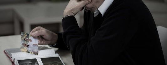 old man looking at photos to reminisce reposted by Made for Freedom