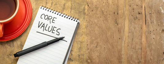 a cup of coffee and a notebook with the words "core values" written on it reposted by Made for Freedom