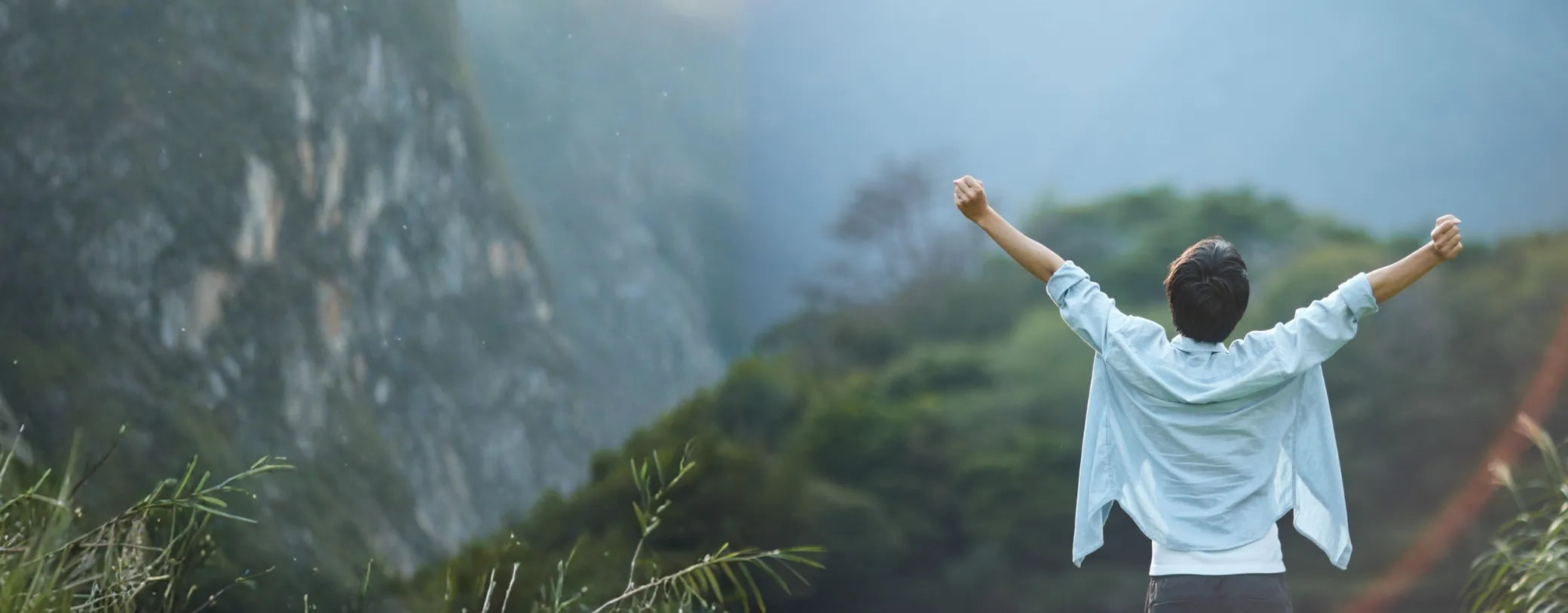 man on a mountain top with his hands raised as a symbol of freedom reposted by Made for Freedom